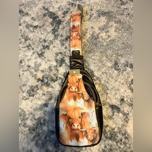 One of a kind faux leather crossbody/backpack with highland cow pattern.